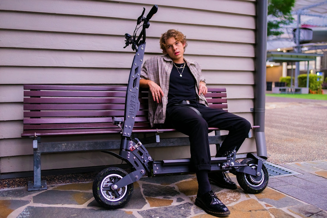 man in black jacket sitting on black and purple wheelchair
