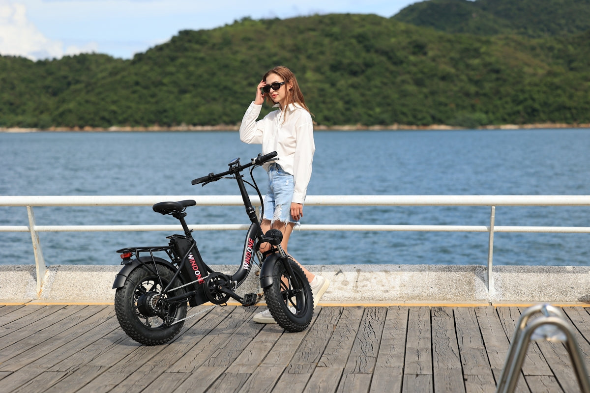 A woman standing next to a bike on a pier
