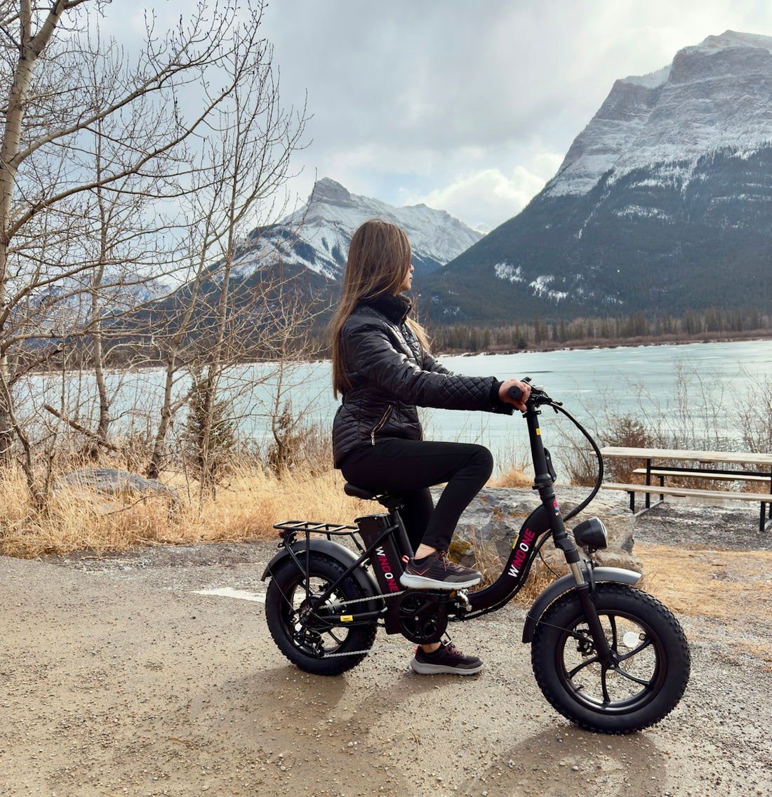 Woman rides an electric bike with mountain views