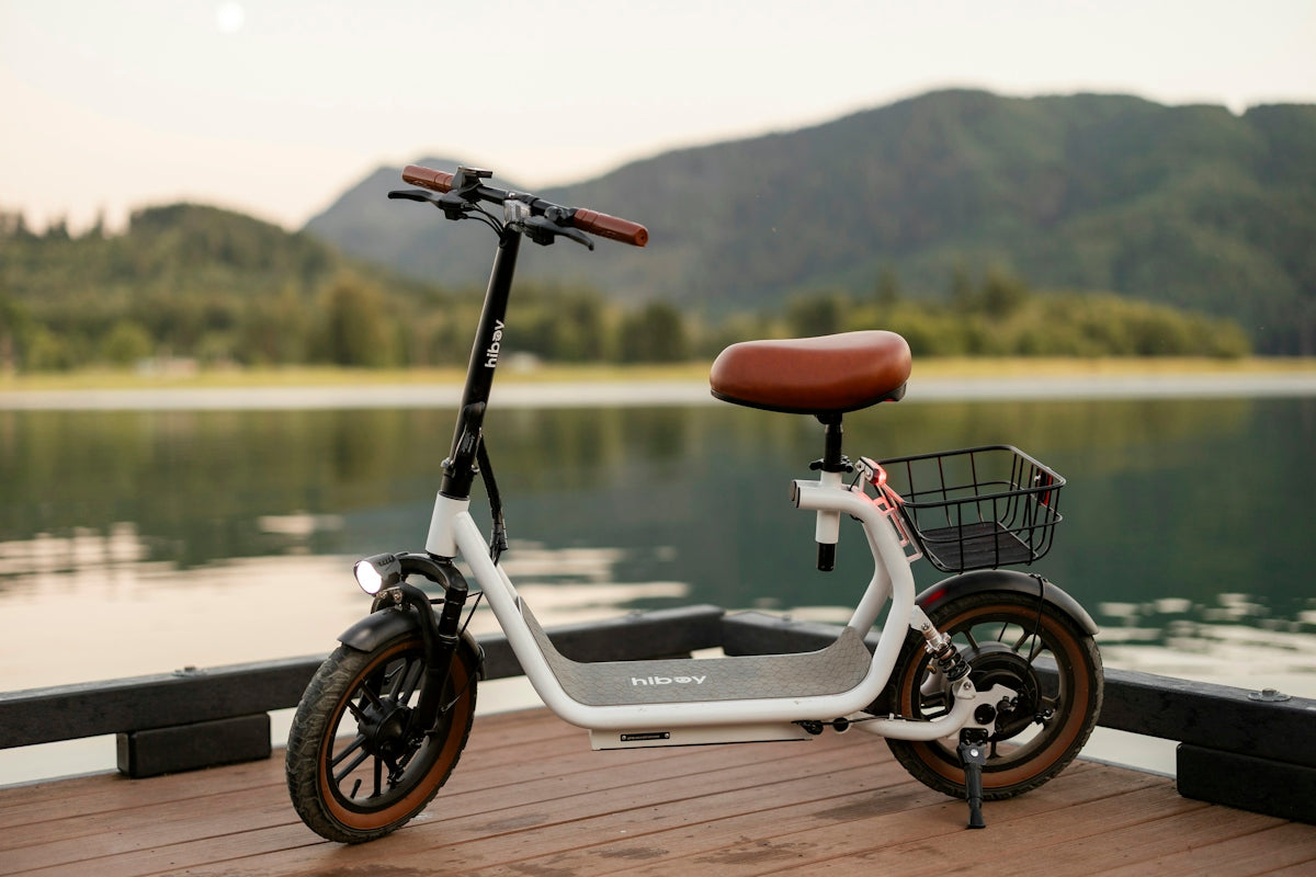 An electric scooter sits next to a lake
